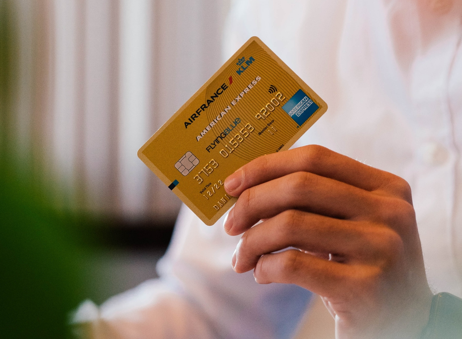 Hand holding an Air France KLM American Express credit card.